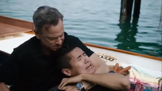 Garret choking a Thai man